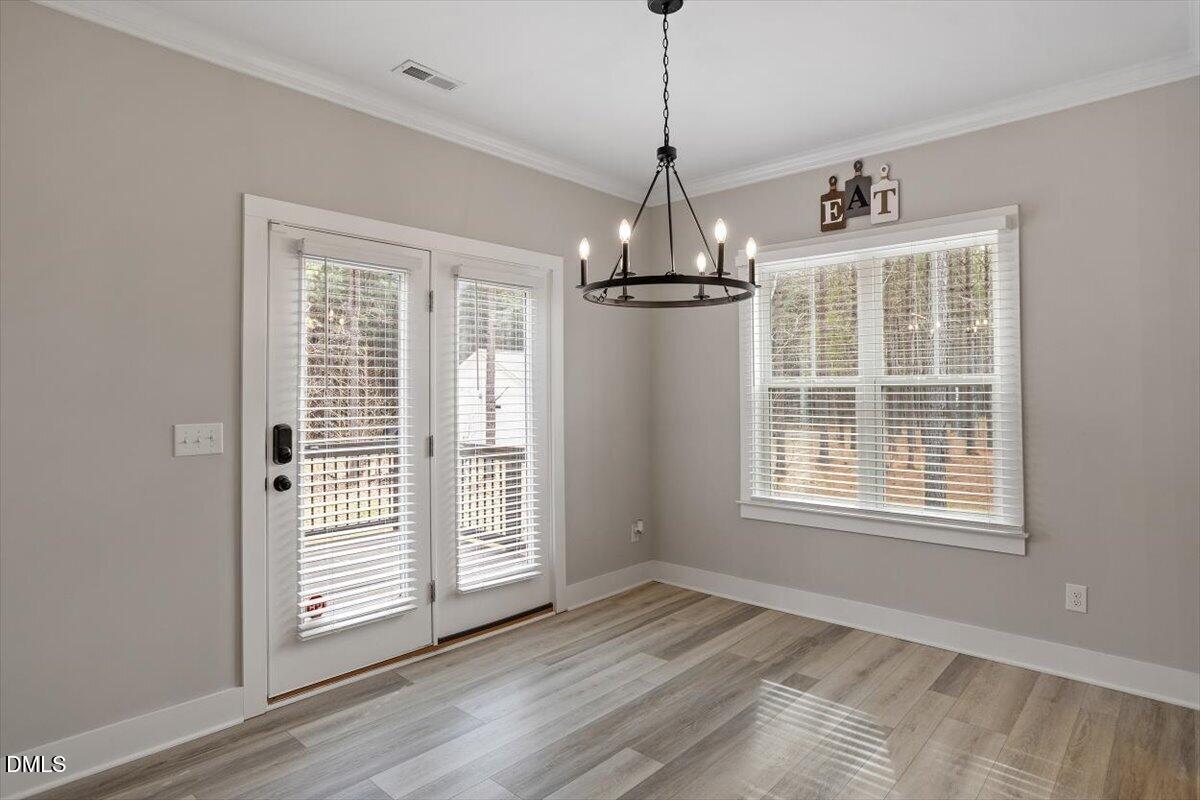 2810 Antioch Church Road Timberlake, NC 27583 - Photo 21 of 34 a view of empty room with wooden floor chandeliers and window