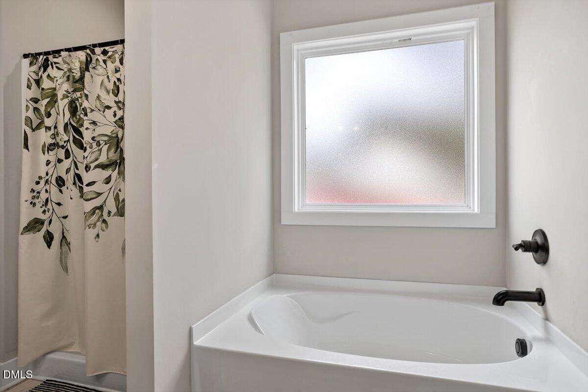 2810 Antioch Church Road Timberlake, NC 27583 - Photo 26 of 34 a white bath tub sitting next to a shower
