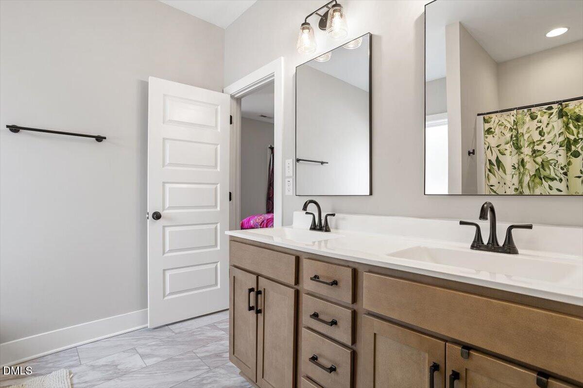 2810 Antioch Church Road Timberlake, NC 27583 - Photo 27 of 34 a bathroom with a double vanity sink mirror and