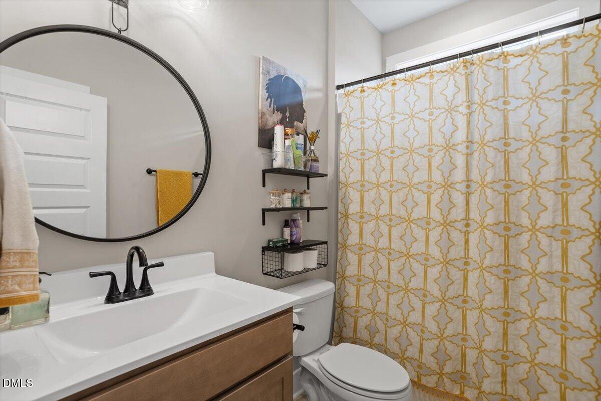 2810 Antioch Church Road Timberlake, NC 27583 - Photo 32 of 34 a bathroom with a sink toilet and mirror