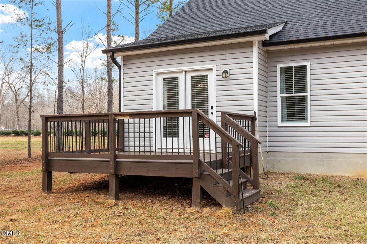 2810 Antioch Church Road Timberlake, NC 27583 - Photo 7 of 34 a view of a wooden house with a yard and wooden fence