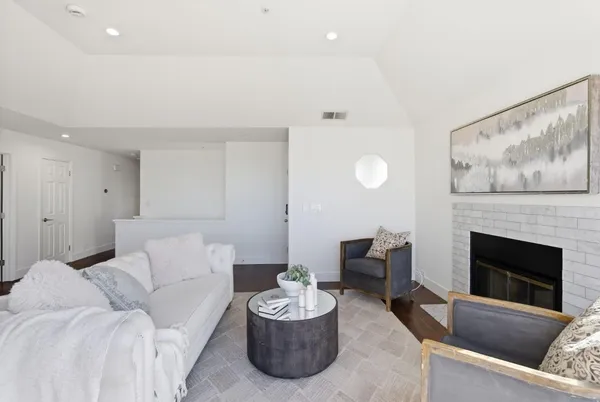 a view of kitchen island with a large window cabinets and stainless steel appliances