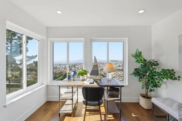 a living room with furniture a table and kitchen view