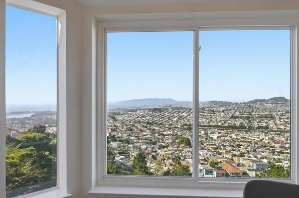 a view of room with cabinet and wooden floor