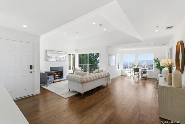 a view of a chairs and table in the balcony