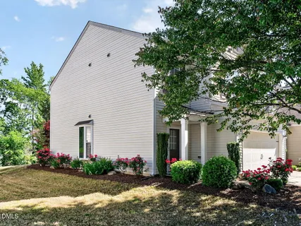 a front view of house with yard and flowers