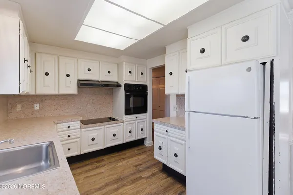 a kitchen with stainless steel appliances a refrigerator sink and cabinets