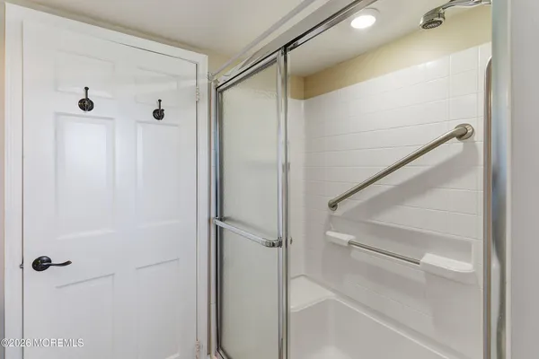 a bathroom with a glass shower door