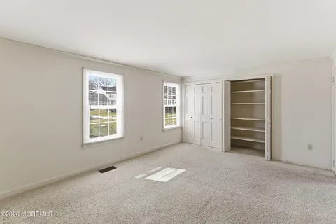 an empty room with a empty space and windows