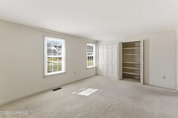 an empty room with a empty space and windows