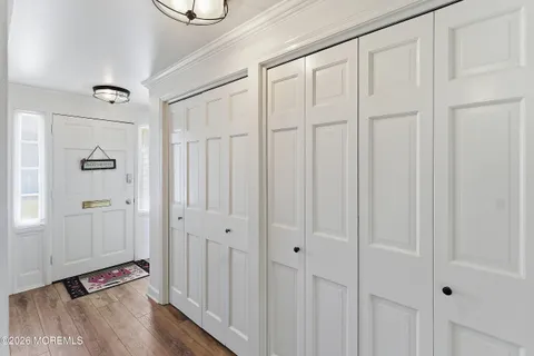 a view of a room with wooden floor