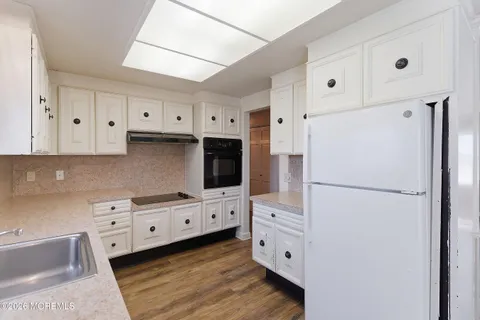 a kitchen with stainless steel appliances a refrigerator sink and cabinets