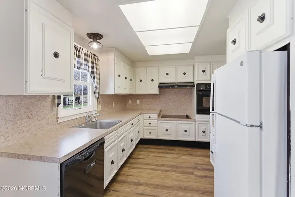 a kitchen with stainless steel appliances a refrigerator sink and cabinets