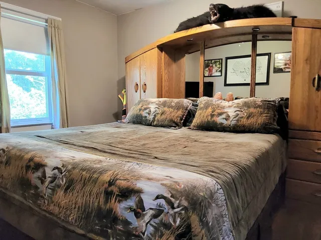 a bedroom with furniture and a window