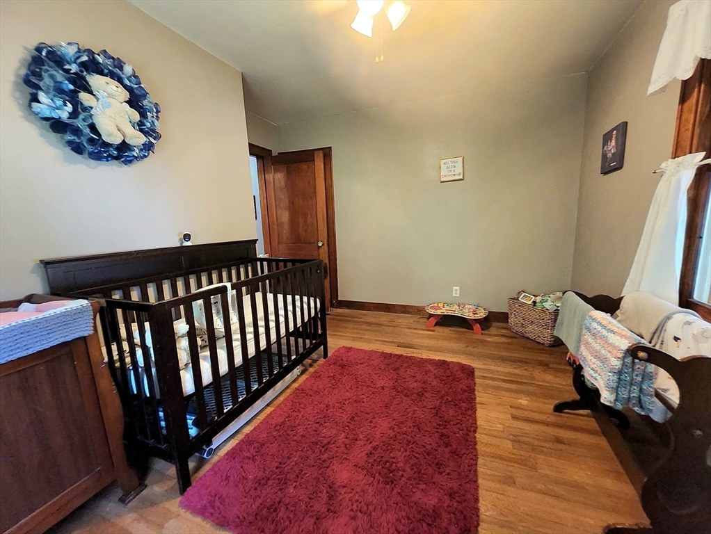 323 New Boston Road Sturbridge, MA 01566 - Photo 19 of 37 a bedroom with a bed and wooden floor
