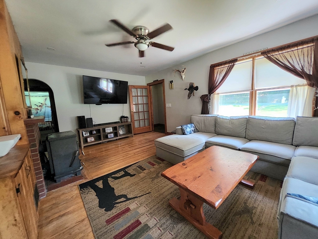 323 New Boston Road Sturbridge, MA 01566 - Photo 3 of 37 a living room with furniture flat screen tv and a large window