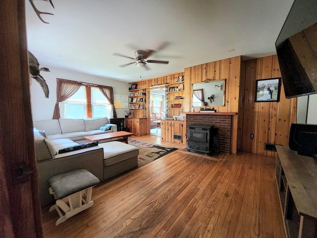 323 New Boston Road Sturbridge, MA 01566 - Photo 4 of 37 a living room with furniture a fireplace and a flat screen tv