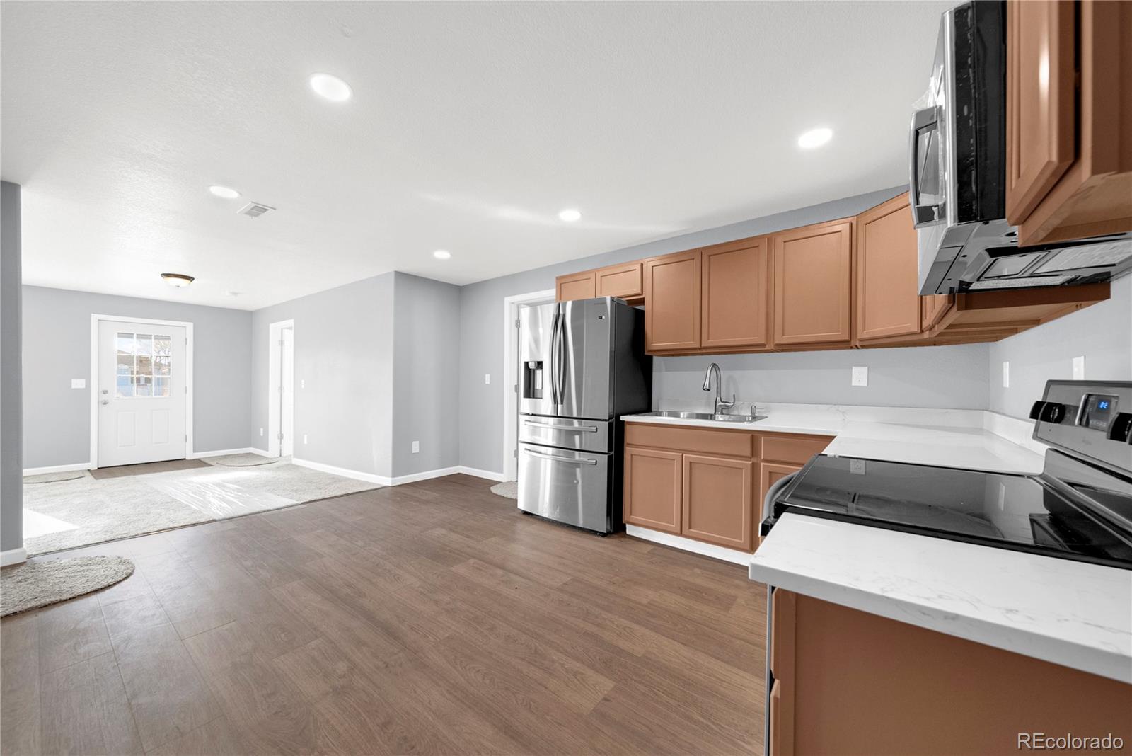222 Platte Street Sterling, CO 80751 - Photo 11 of 24 a kitchen with stainless steel appliances a refrigerator and a stove top oven