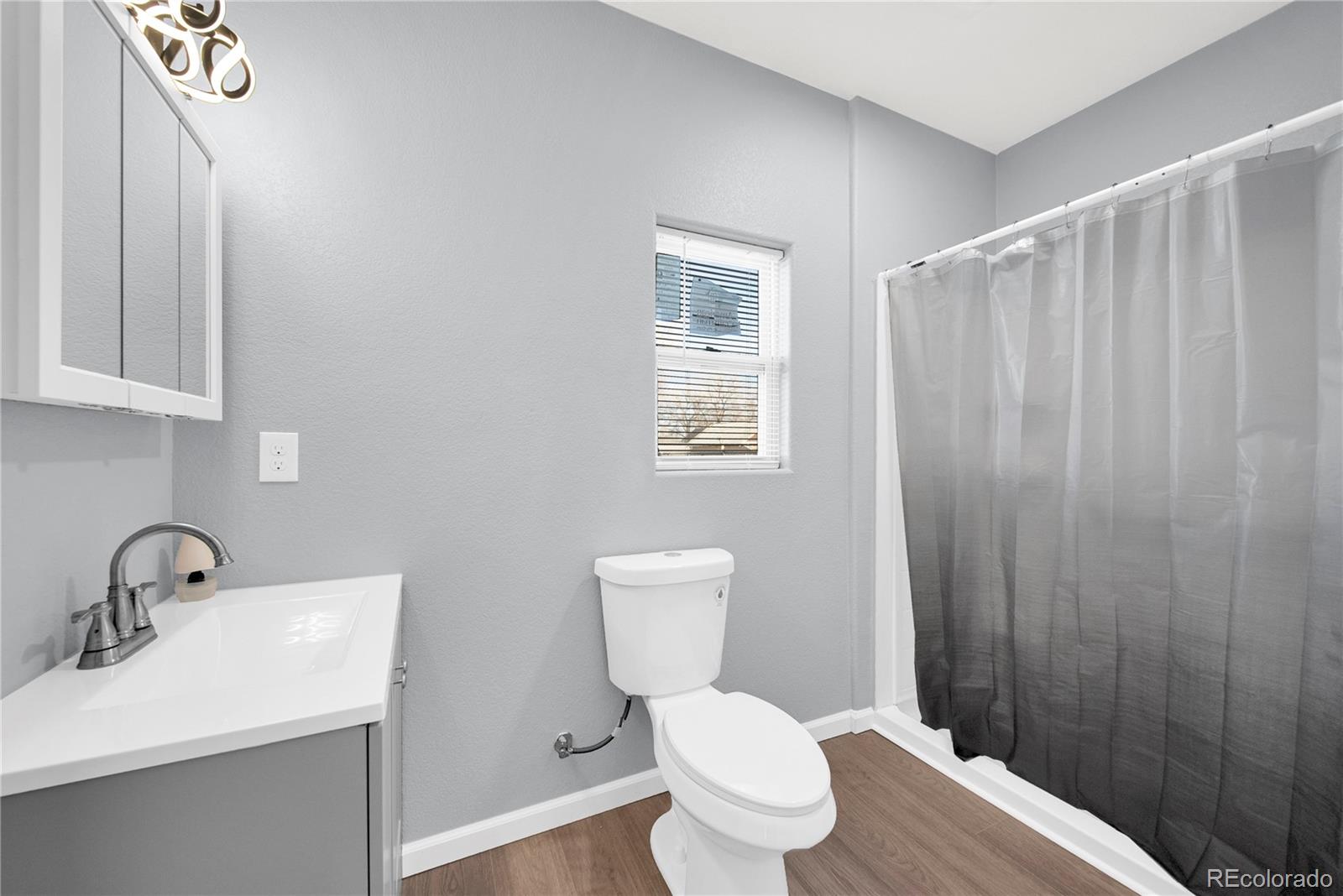 222 Platte Street Sterling, CO 80751 - Photo 13 of 24 a bathroom with a sink a toilet and a mirror
