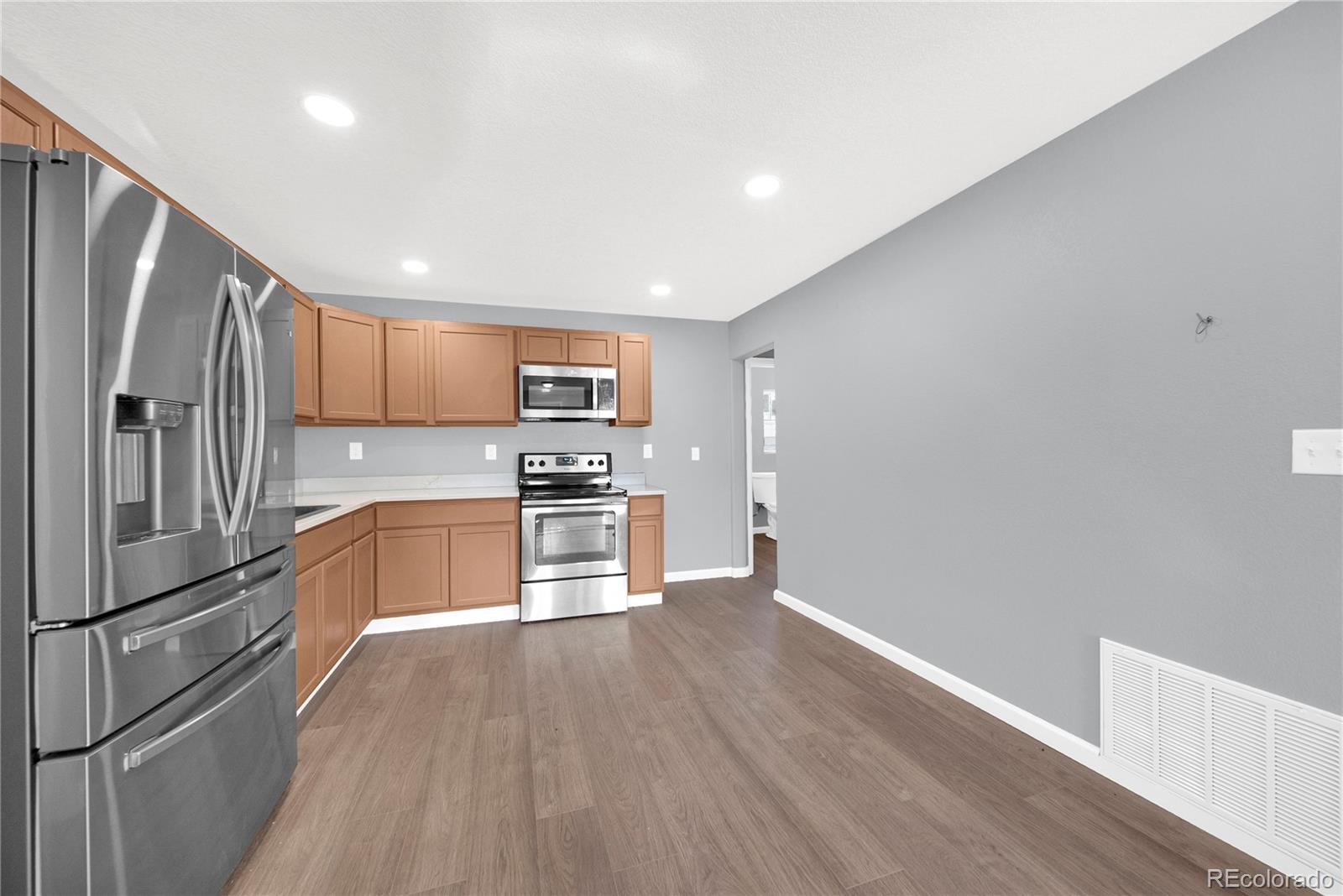222 Platte Street Sterling, CO 80751 - Photo 9 of 24 a kitchen with stainless steel appliances a refrigerator and a stove top oven