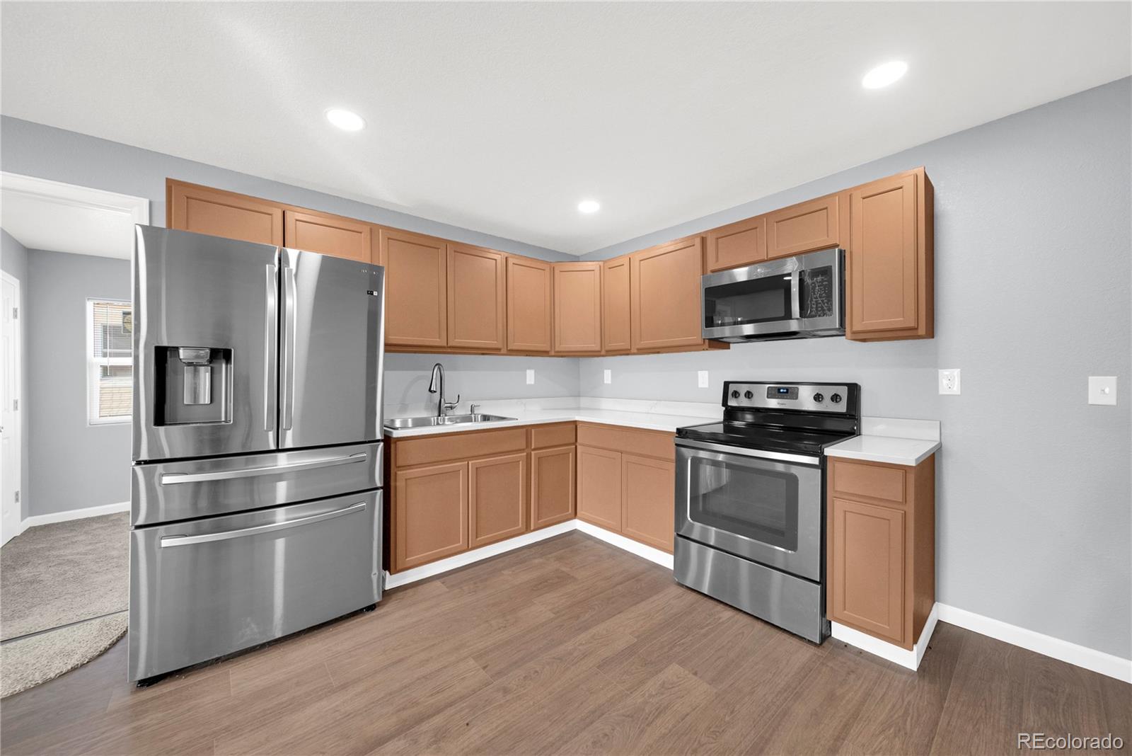 222 Platte Street Sterling, CO 80751 - Photo 10 of 24 a kitchen with stainless steel appliances a refrigerator and a stove top oven