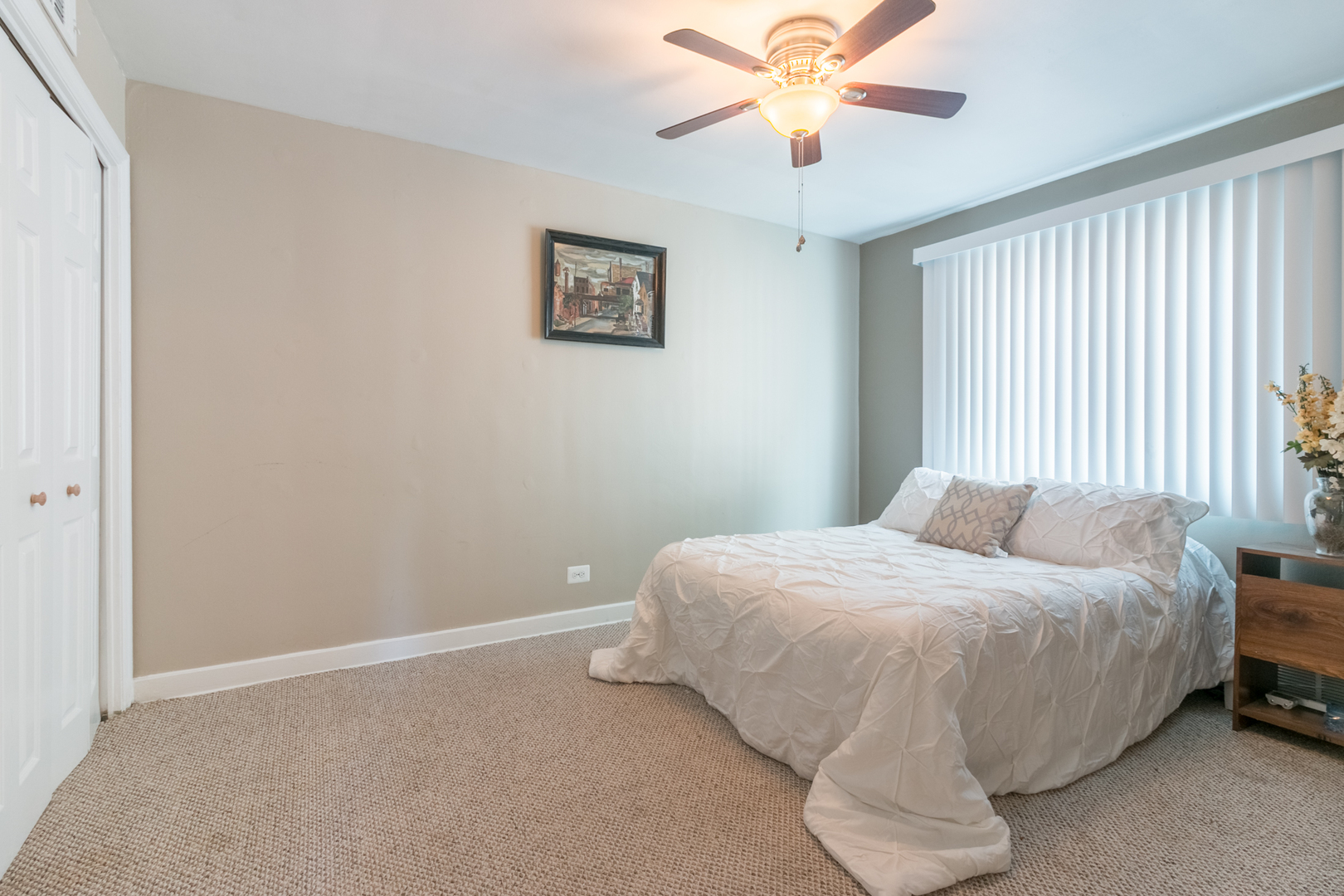 8518 East Prairie Road Skokie, IL 60076 - Photo 11 of 17 a bedroom with a bed and a chandelier
