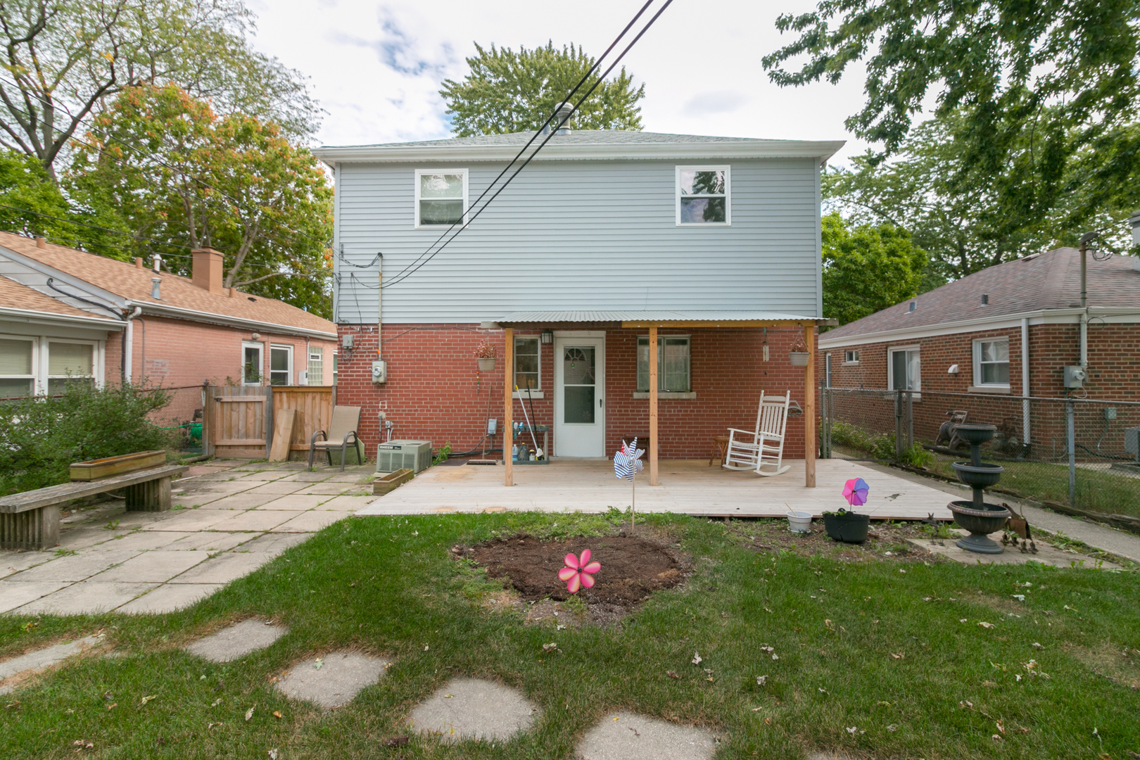 8518 East Prairie Road Skokie, IL 60076 - Photo 15 of 17 a front view of house with yard and outdoor seating