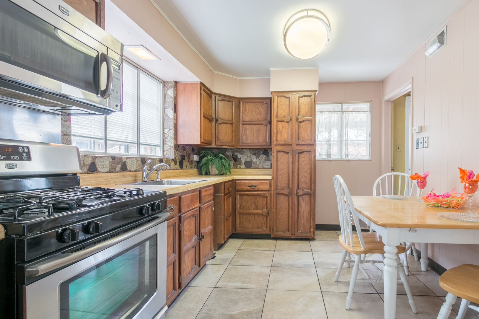 8518 East Prairie Road Skokie, IL 60076 - Photo 4 of 17 a kitchen with a stove a sink and a refrigerator