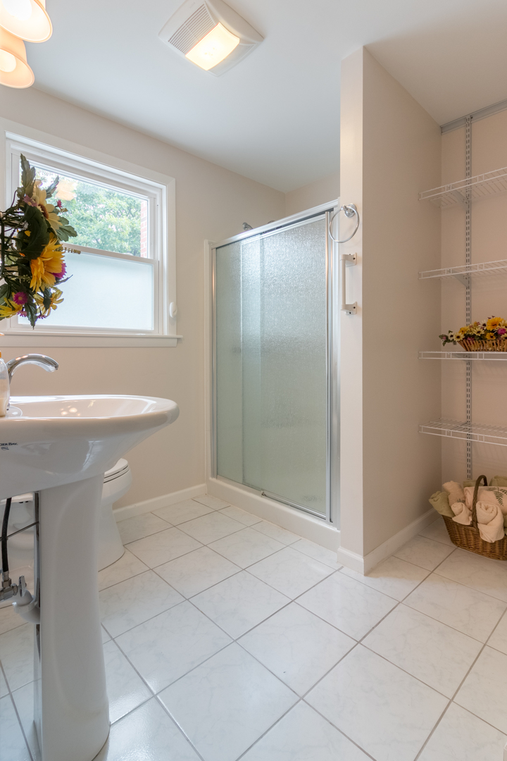 8518 East Prairie Road Skokie, IL 60076 - Photo 9 of 17 a bathroom with a sink toilet and shower