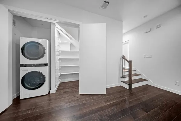 a bedroom with a bed a chandelier and a large window