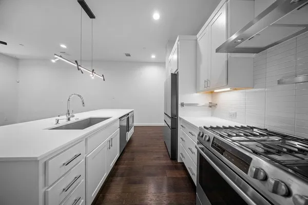 a kitchen with a sink stainless steel appliances and cabinets