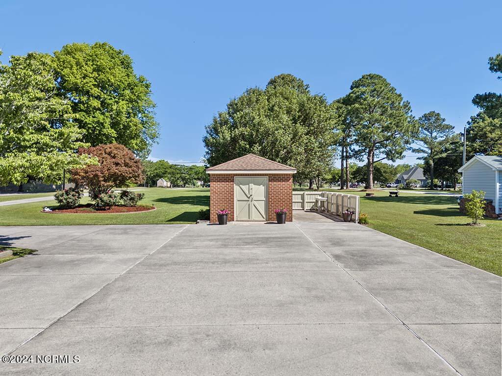 145 Ferry Dock Road Knotts Island, NC 27950 - Photo 60 of 79 Fenced area around a spacious brick shed.