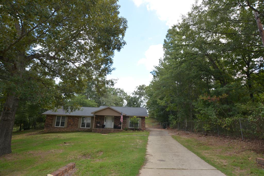 9 Lott Road Phenix City, AL 36869 - Photo 1 of 23 a front view of a house with a garden