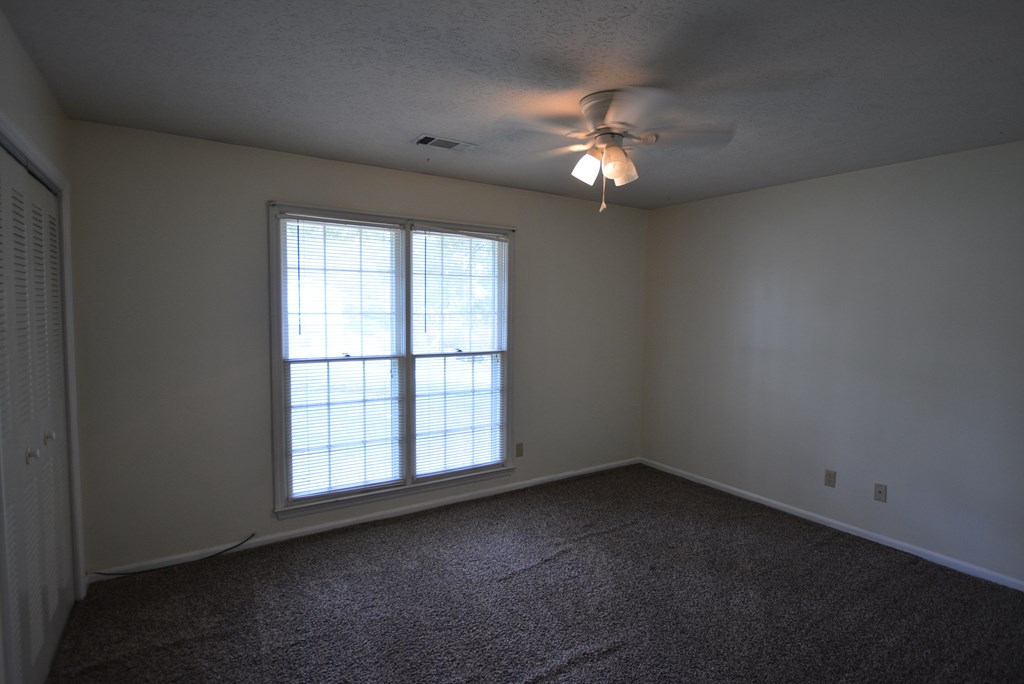 9 Lott Road Phenix City, AL 36869 - Photo 11 of 23 an empty room with windows and chandelier fan