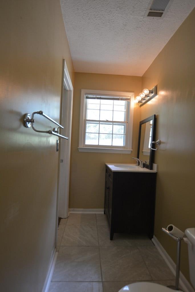 9 Lott Road Phenix City, AL 36869 - Photo 14 of 23 a room with a mirror and a window