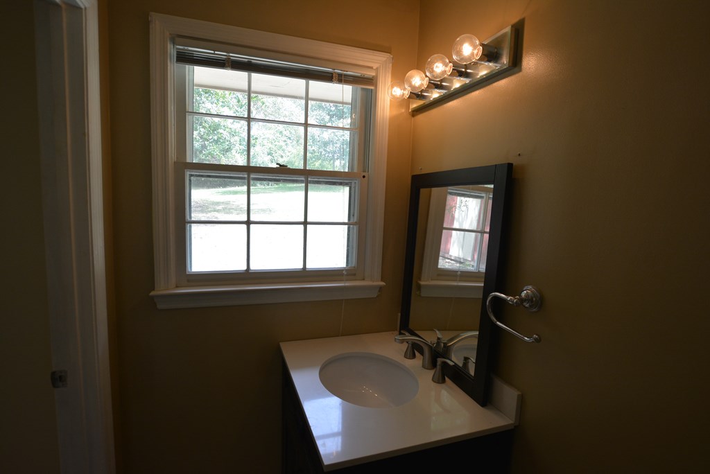 9 Lott Road Phenix City, AL 36869 - Photo 15 of 23 a bathroom with a sink a mirror and a window