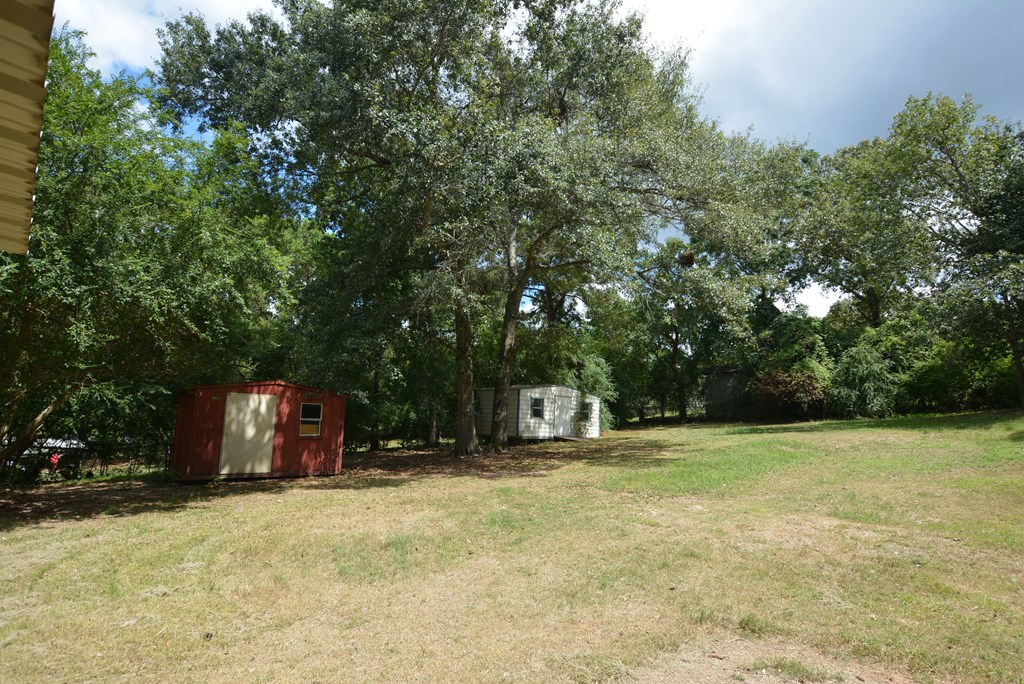 9 Lott Road Phenix City, AL 36869 - Photo 18 of 23 a backyard of a house with table and chairs