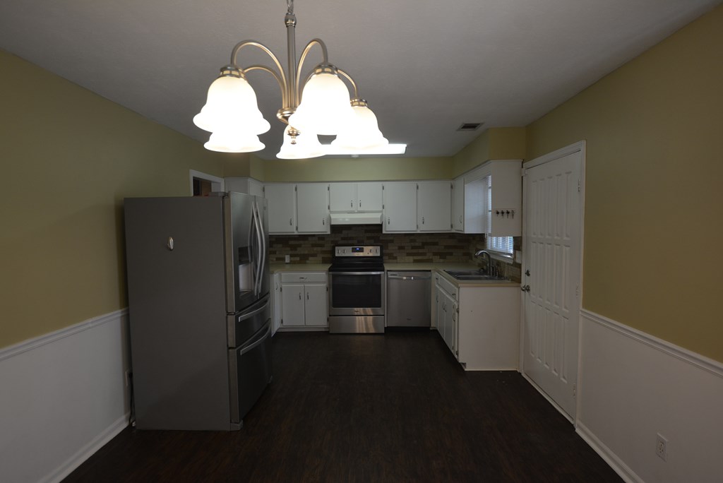 9 Lott Road Phenix City, AL 36869 - Photo 2 of 23 a kitchen with cabinets and stainless steel appliances