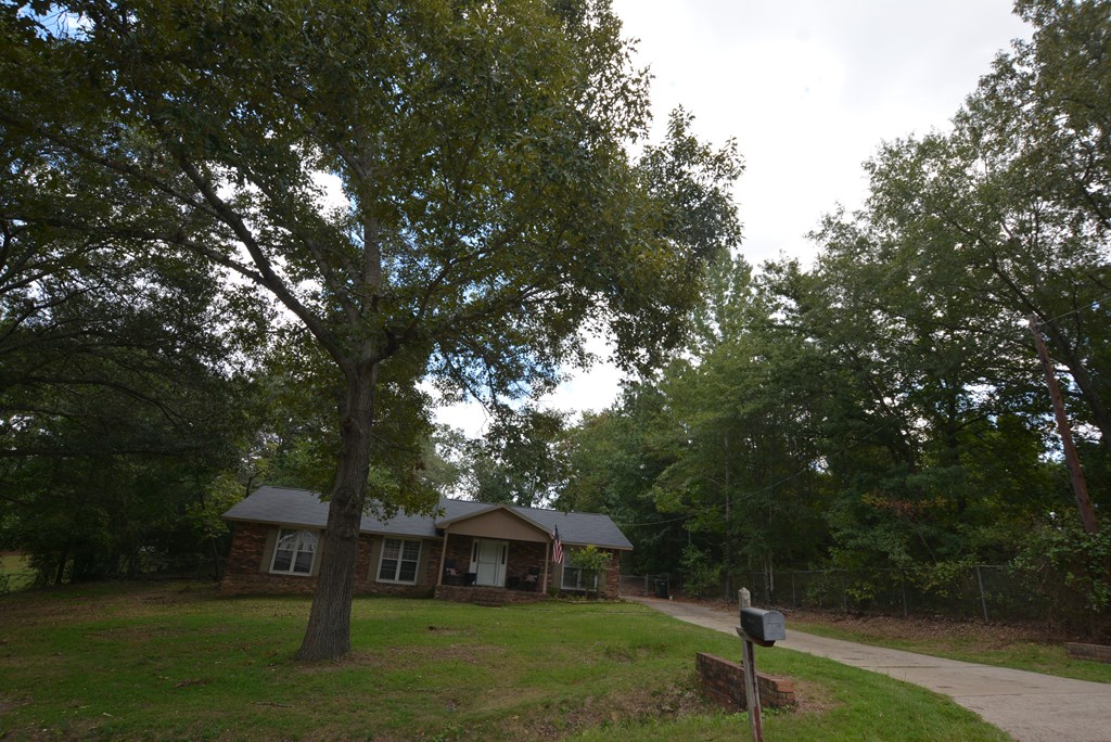 9 Lott Road Phenix City, AL 36869 - Photo 23 of 23 a front view of a house with garden and trees