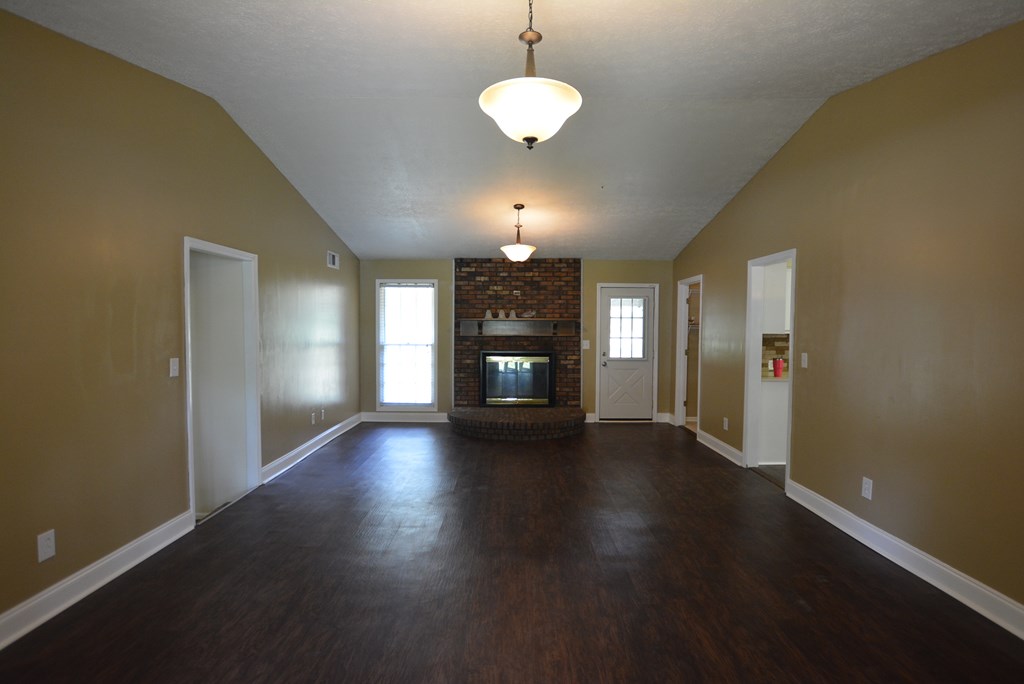 9 Lott Road Phenix City, AL 36869 - Photo 5 of 23 a view of a livingroom with wooden floor a ceiling fan and window