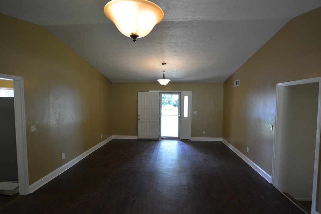 9 Lott Road Phenix City, AL 36869 - Photo 6 of 23 an empty room with wooden floor and windows