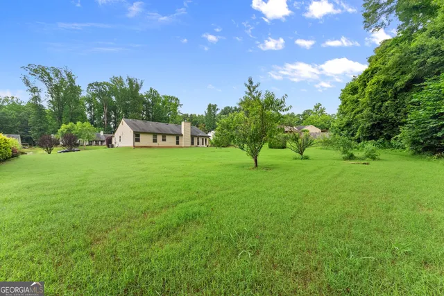 swimming pool view with garden space and seating area