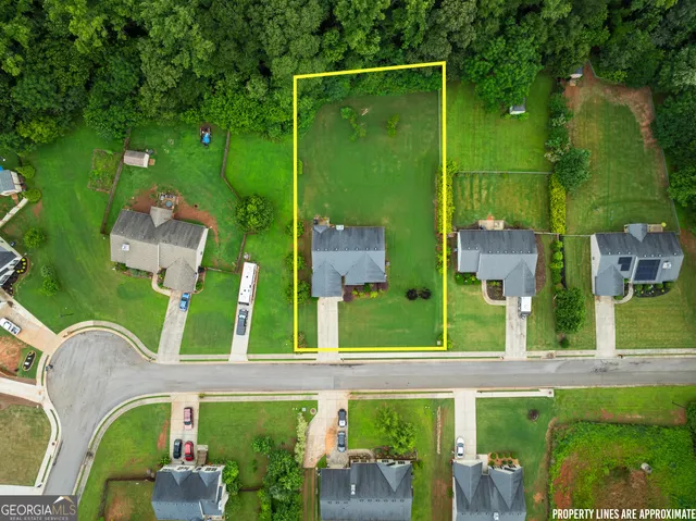 an aerial view of residential houses with outdoor space and street view