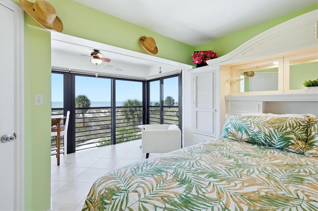 5000 Gasparilla Road, Unit BC205 Boca Grande, FL 33921 - Photo 13 of 50 a bedroom with a bed and a large window