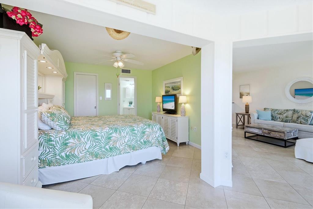 5000 Gasparilla Road, Unit BC205 Boca Grande, FL 33921 - Photo 16 of 50 a bedroom with a bed and a chandelier