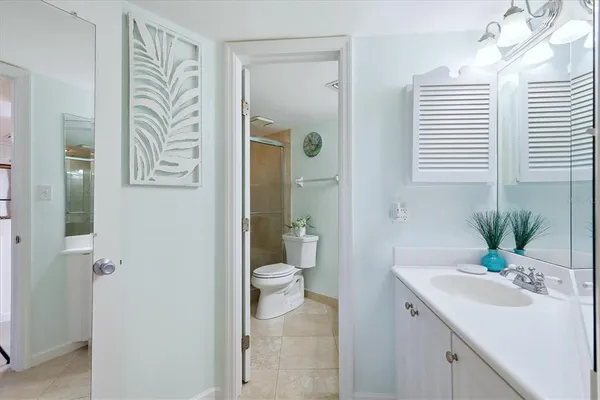 a bathroom with a sink toilet a mirror and shower