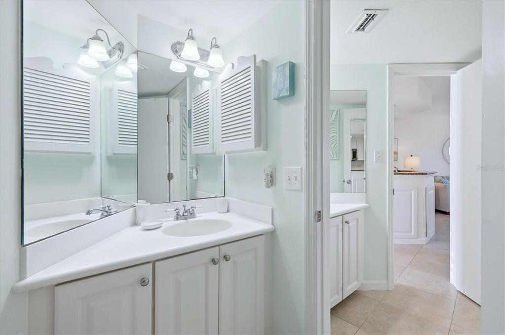 5000 Gasparilla Road, Unit BC205 Boca Grande, FL 33921 - Photo 19 of 50 a bathroom with a sink double vanity and a mirror
