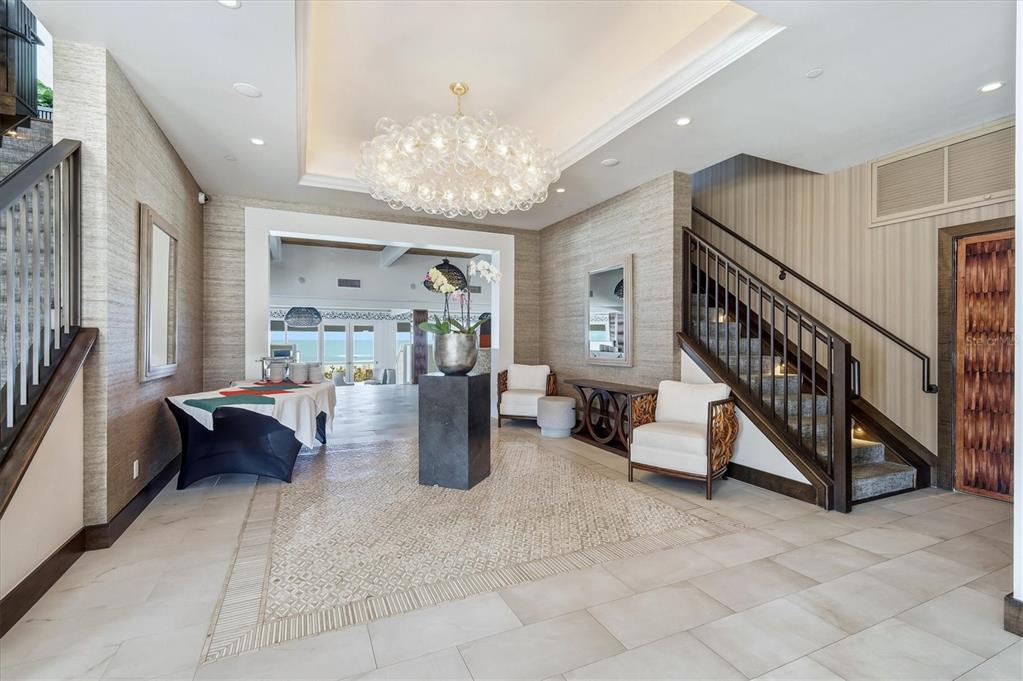 5000 Gasparilla Road, Unit BC205 Boca Grande, FL 33921 - Photo 24 of 50 a living room with furniture and a chandelier