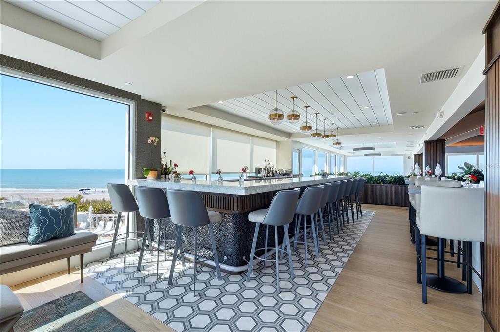 5000 Gasparilla Road, Unit BC205 Boca Grande, FL 33921 - Photo 28 of 50 a dining hall with furniture a table and kitchen view