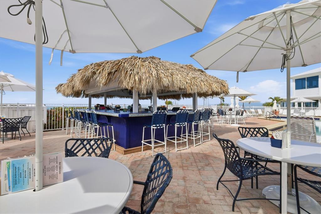 5000 Gasparilla Road, Unit BC205 Boca Grande, FL 33921 - Photo 30 of 50 a patio with a patio table and chairs